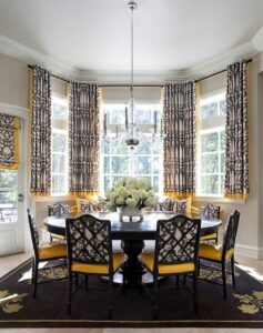 dining room bay window covered with short curtains and